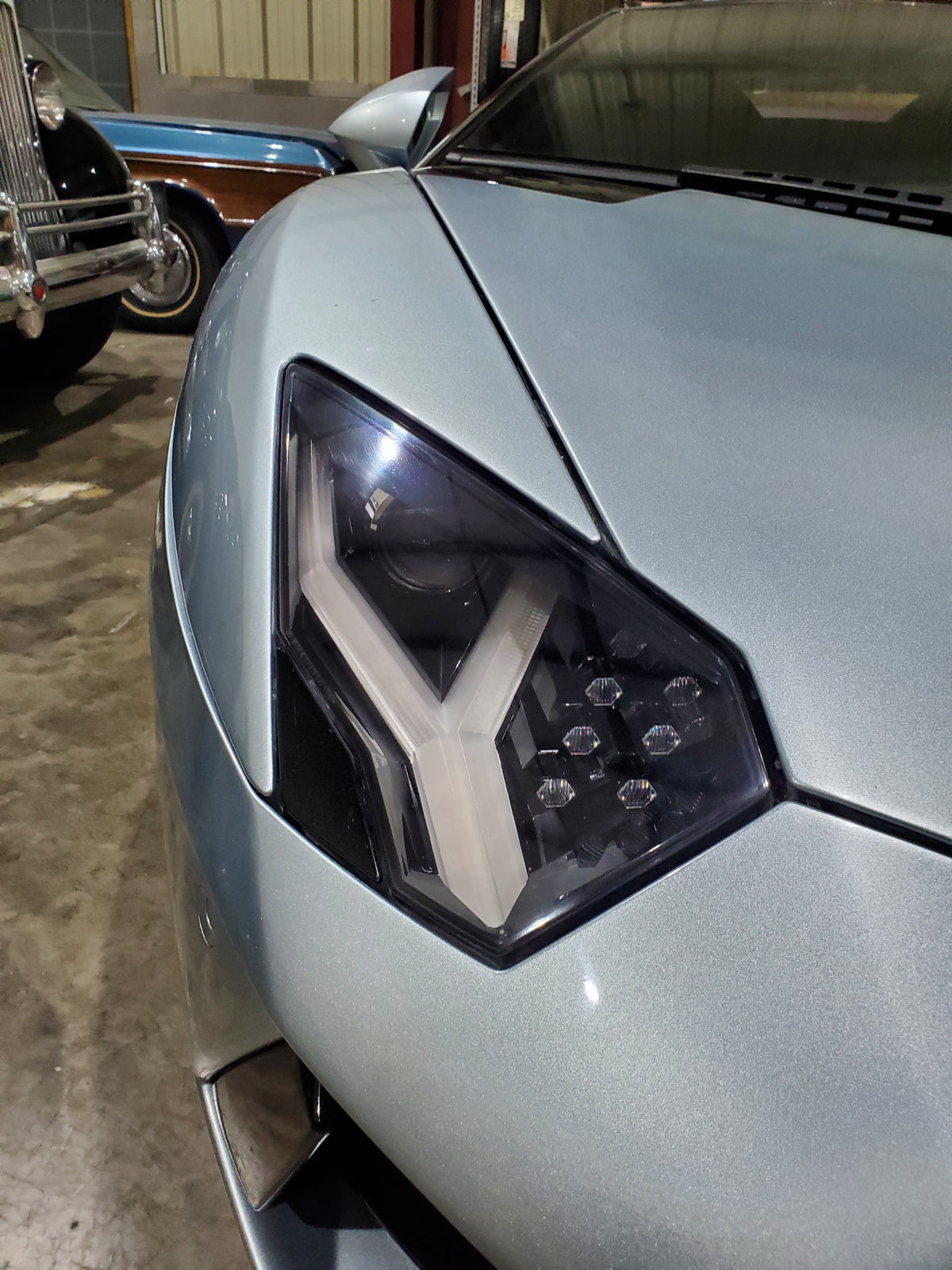 Picture of Lamborghini Aventador headlight after headlight restoration was performed by headlight cleaners mobile car detailing
